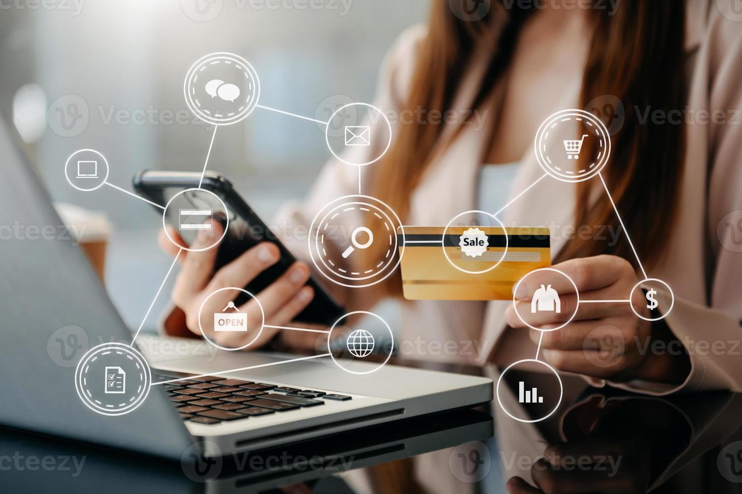 Close up of Hand using credit card and smartphone, laptop computer on wooden desk with VR icon chart graph diagram photo