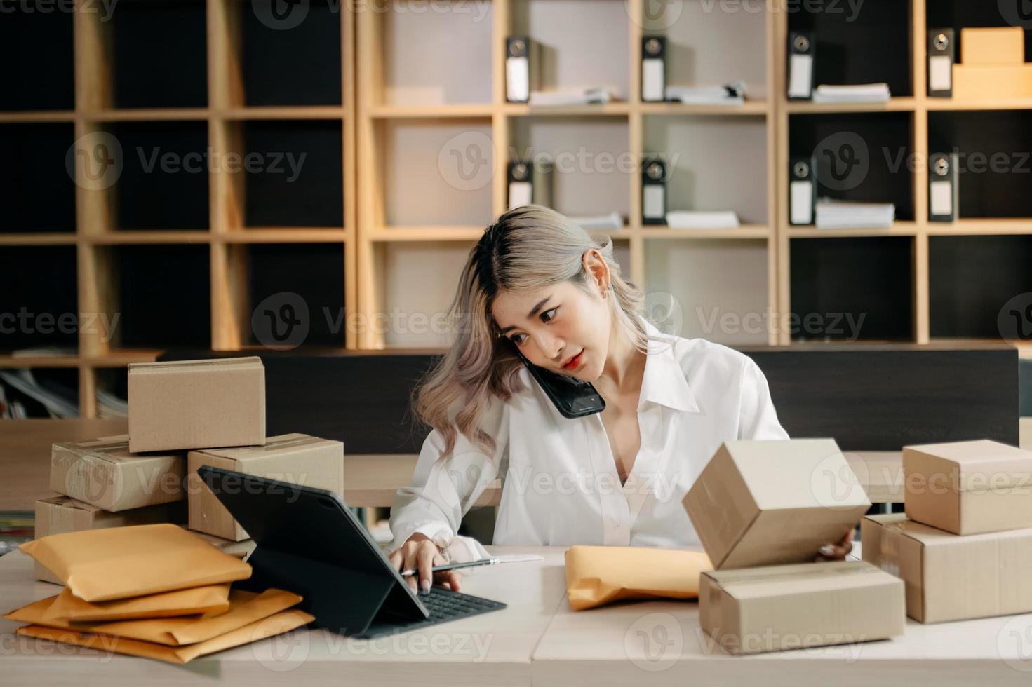Small business entrepreneur SME freelance woman working at home office, BOX,tablet and laptop online, marketing, packaging, delivery,  e commerce concept photo
