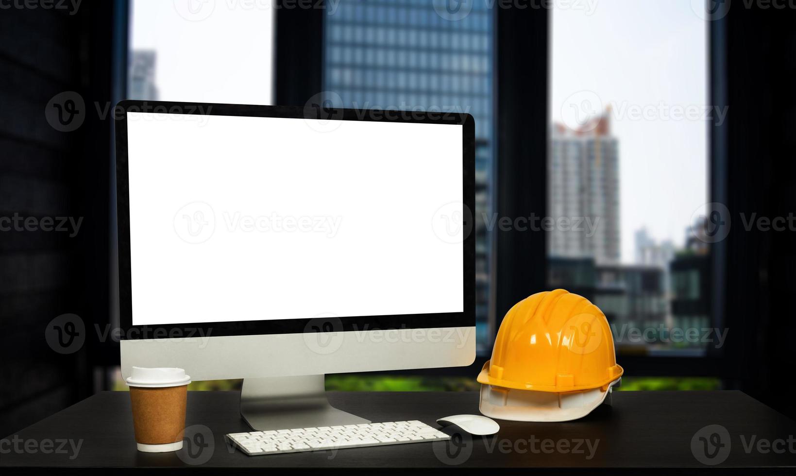 Front view of laptop computer and office construction on table in office blurred background.Architect concept. photo