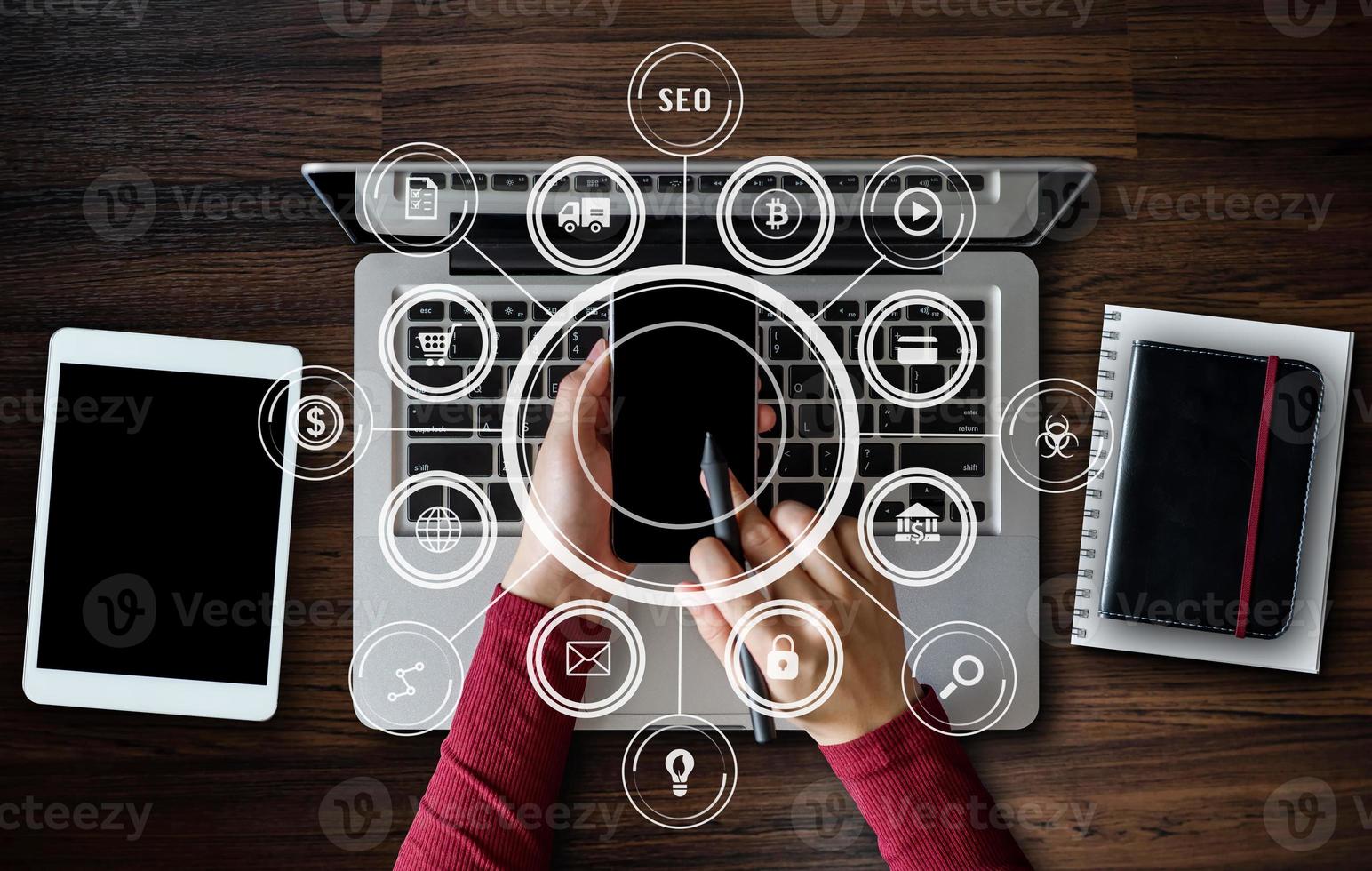 Top view business hand working with laptop computer, tablet and smart phone in office with digital marketing media  in virtual icon photo