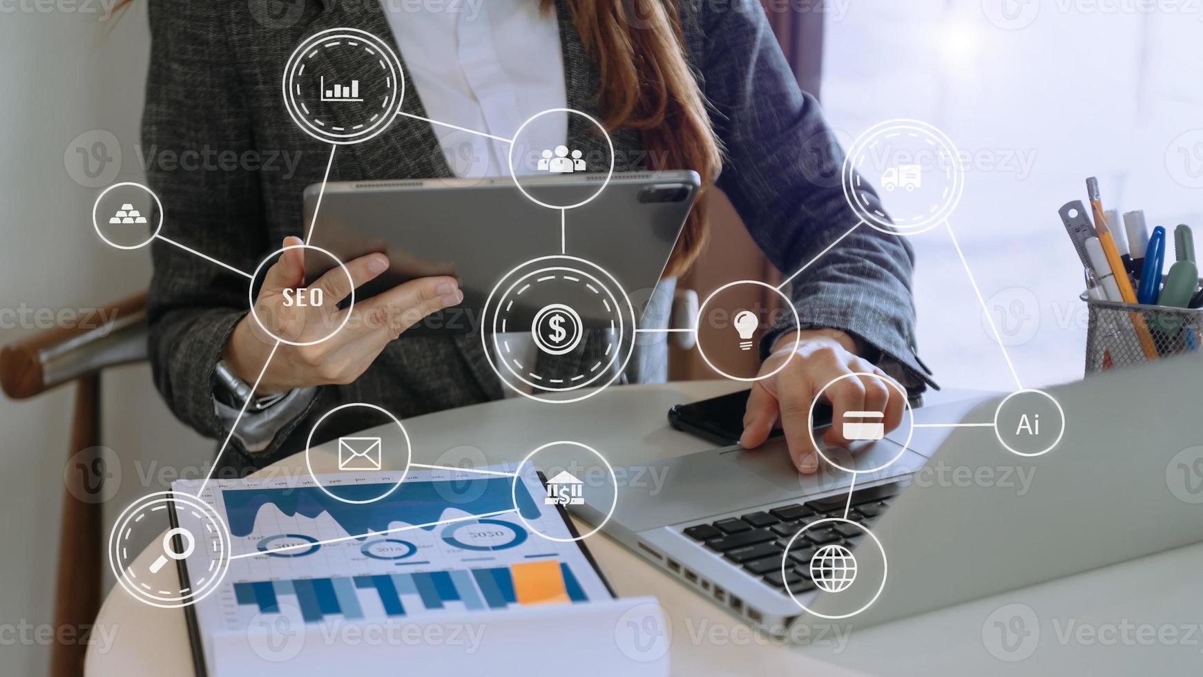 Businessman using mobile phone and laptop computer with business intelligence concept. with VR icon photo