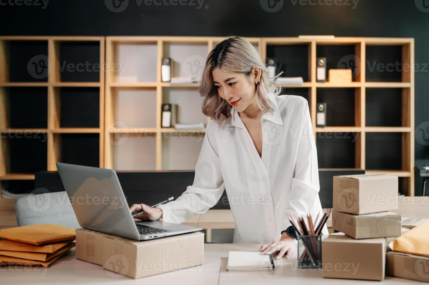 Small business entrepreneur SME freelance woman working at home office, BOX,tablet and laptop online, marketing, packaging, delivery,  e-commerce concept photo