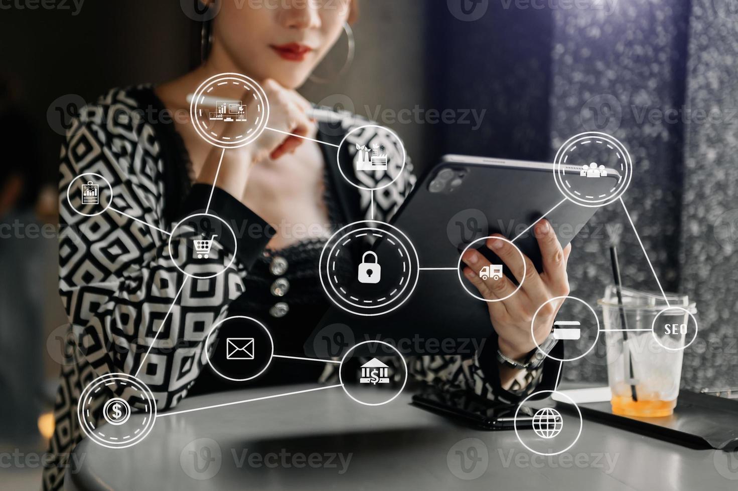 close up of businesswoman working with laptop computer and smart phone on desk in modern office with virtual icon diagram photo