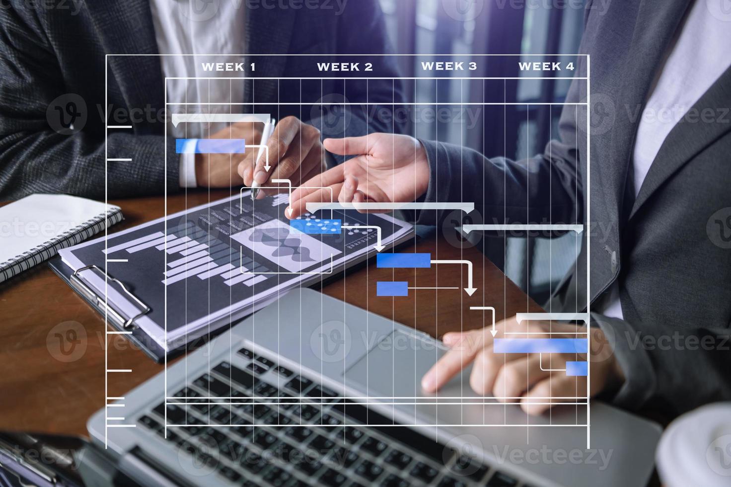 Project manager working and update tasks with milestones progress planning and Gantt chart scheduling diagram. business working with smart phone, tablet and laptop in office. photo