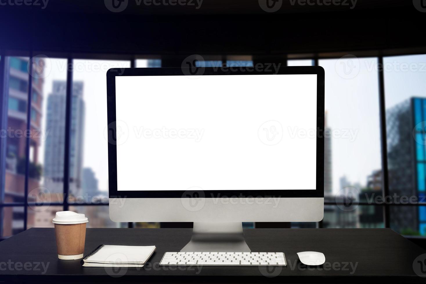 Front view workspace with computer, smartphone and tablet on white desk with blurred background at office photo