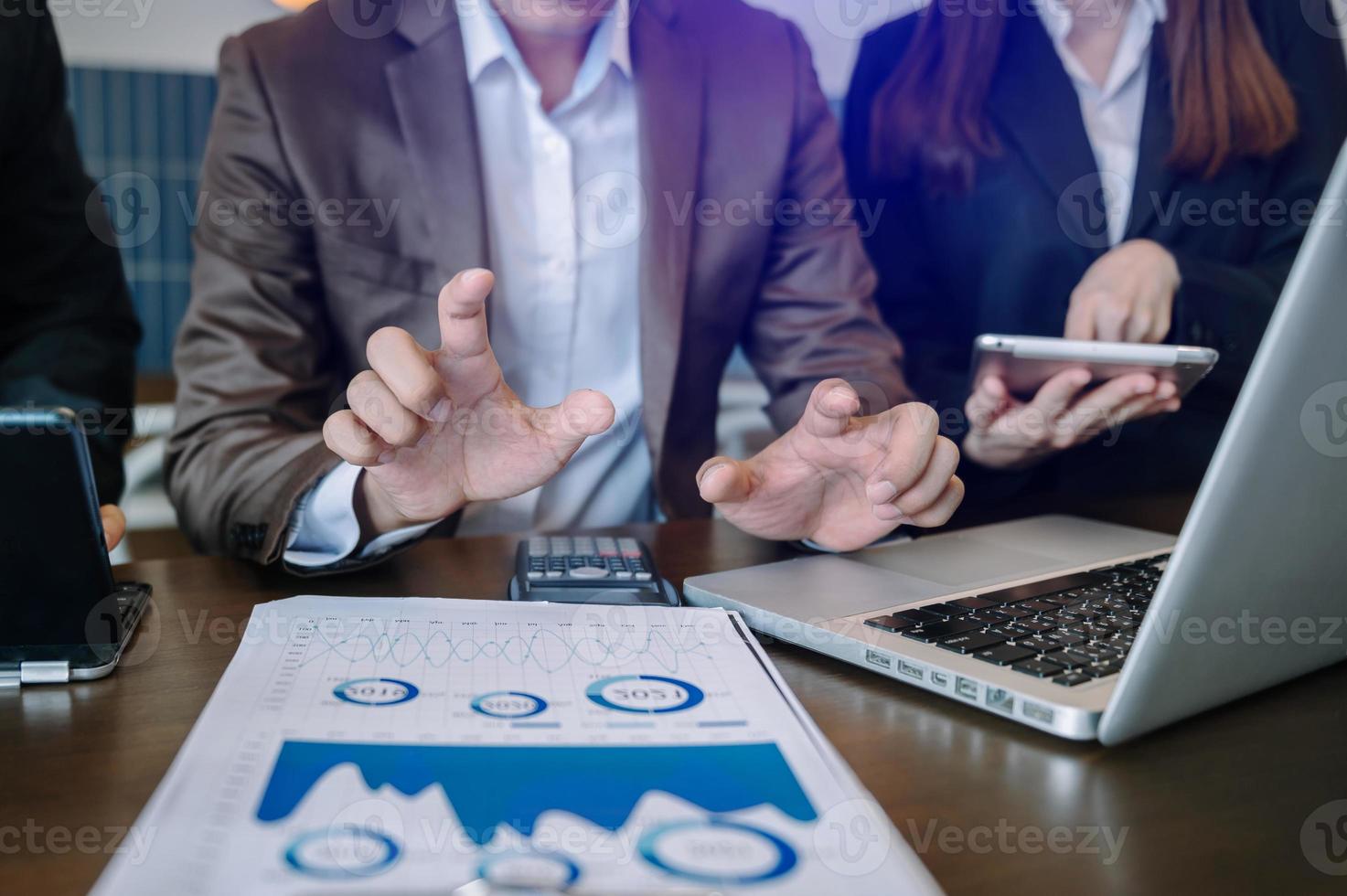 Business documents on office table with smart phone and calculator digital tablet and graph business with social network diagram and two colleagues discussing data working photo