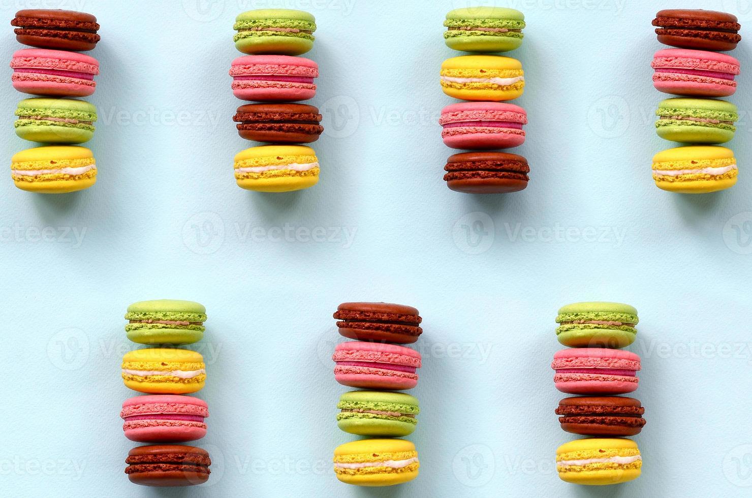 Dessert cake macaron or macaroon on trendy pastel blue background top view. Flat lay composition photo