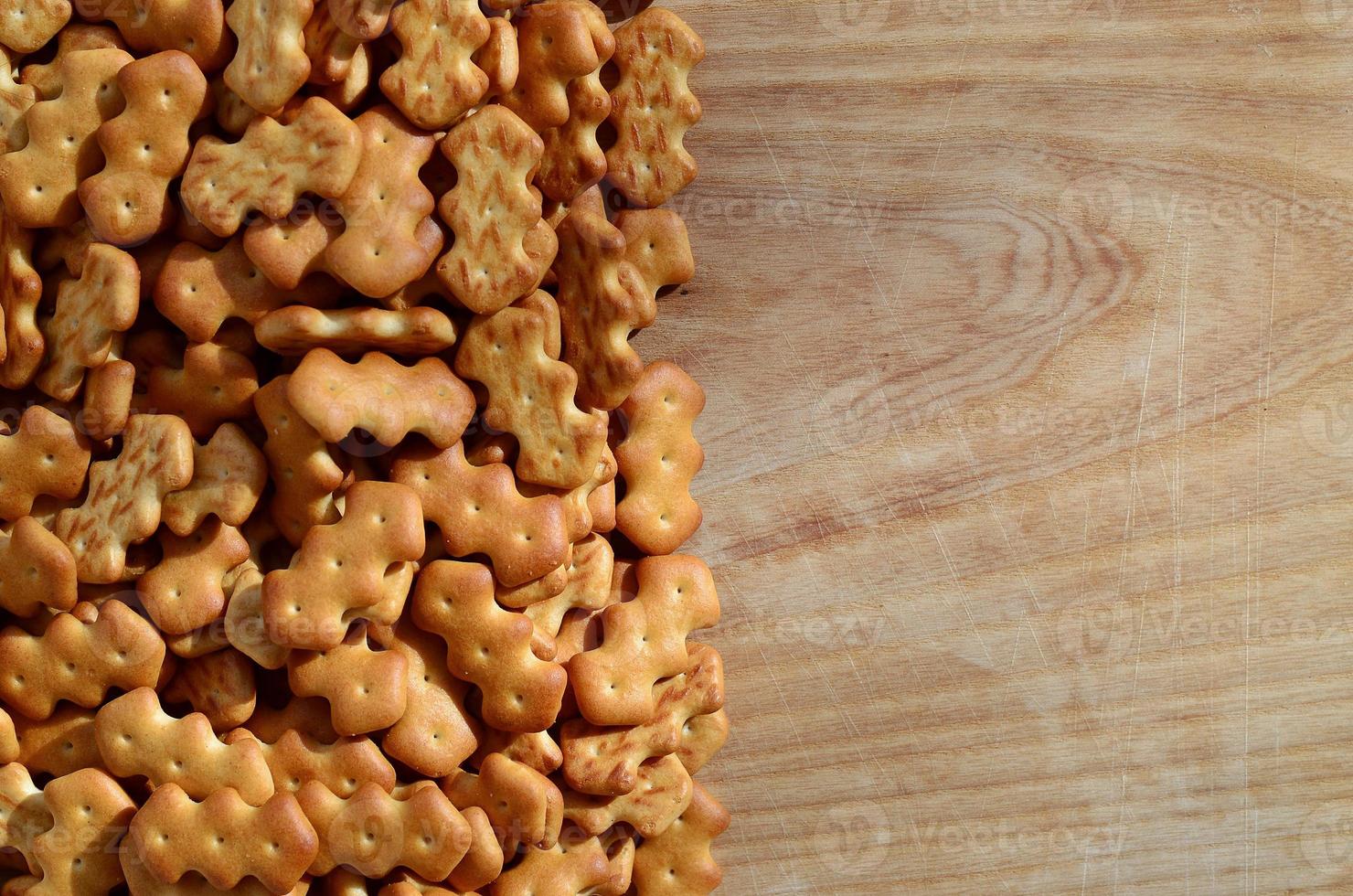 Many salted crackers on a cutting board with copy space photo