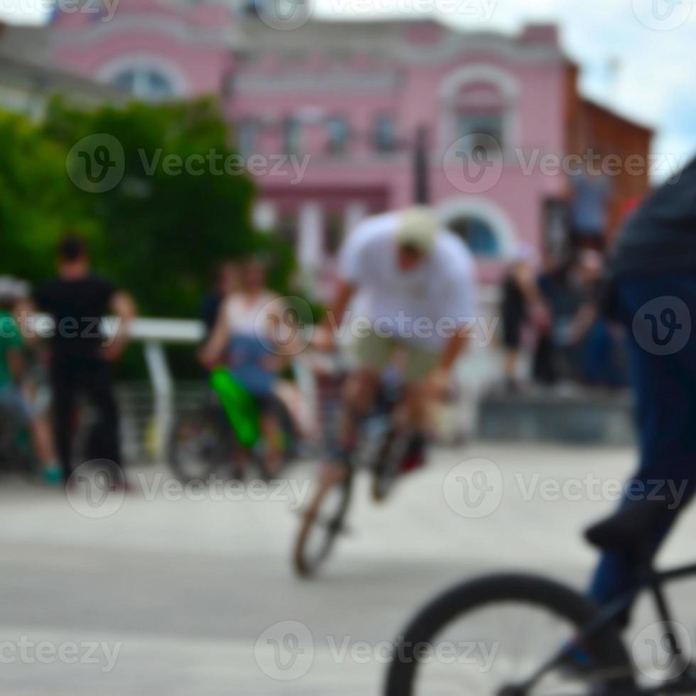 Defocused image of a lot of people with bmx bikes. Meeting of fans of extreme sports photo