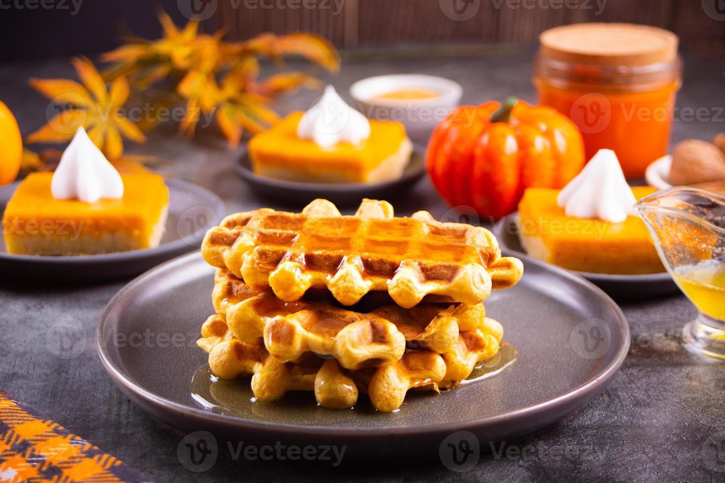 Autumn homemade pumpkin spice waffles with honey topping. photo