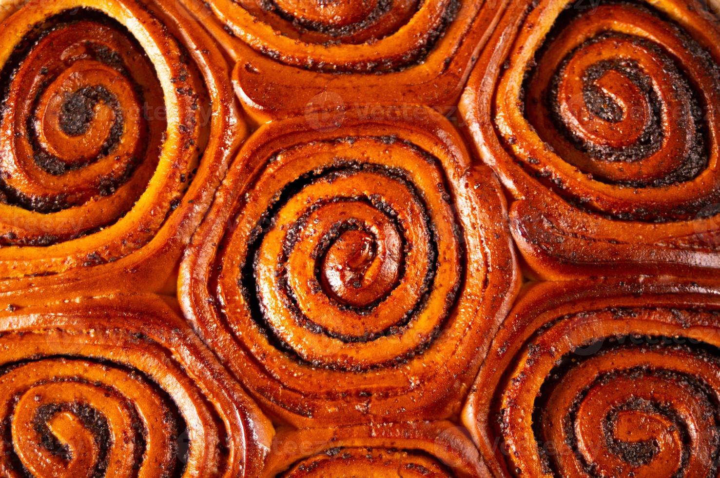 Freshly baked sweet cinnamon bun roll swirl pattern background photo