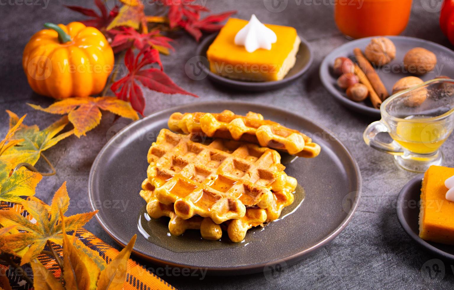 Autumn homemade pumpkin spice waffles with honey topping. photo