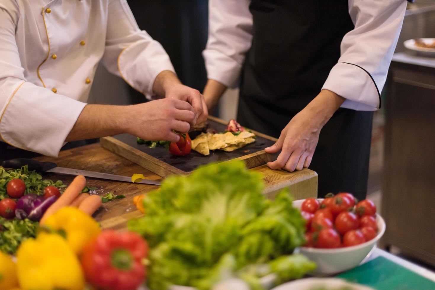 team cooks and chefs preparing meal photo