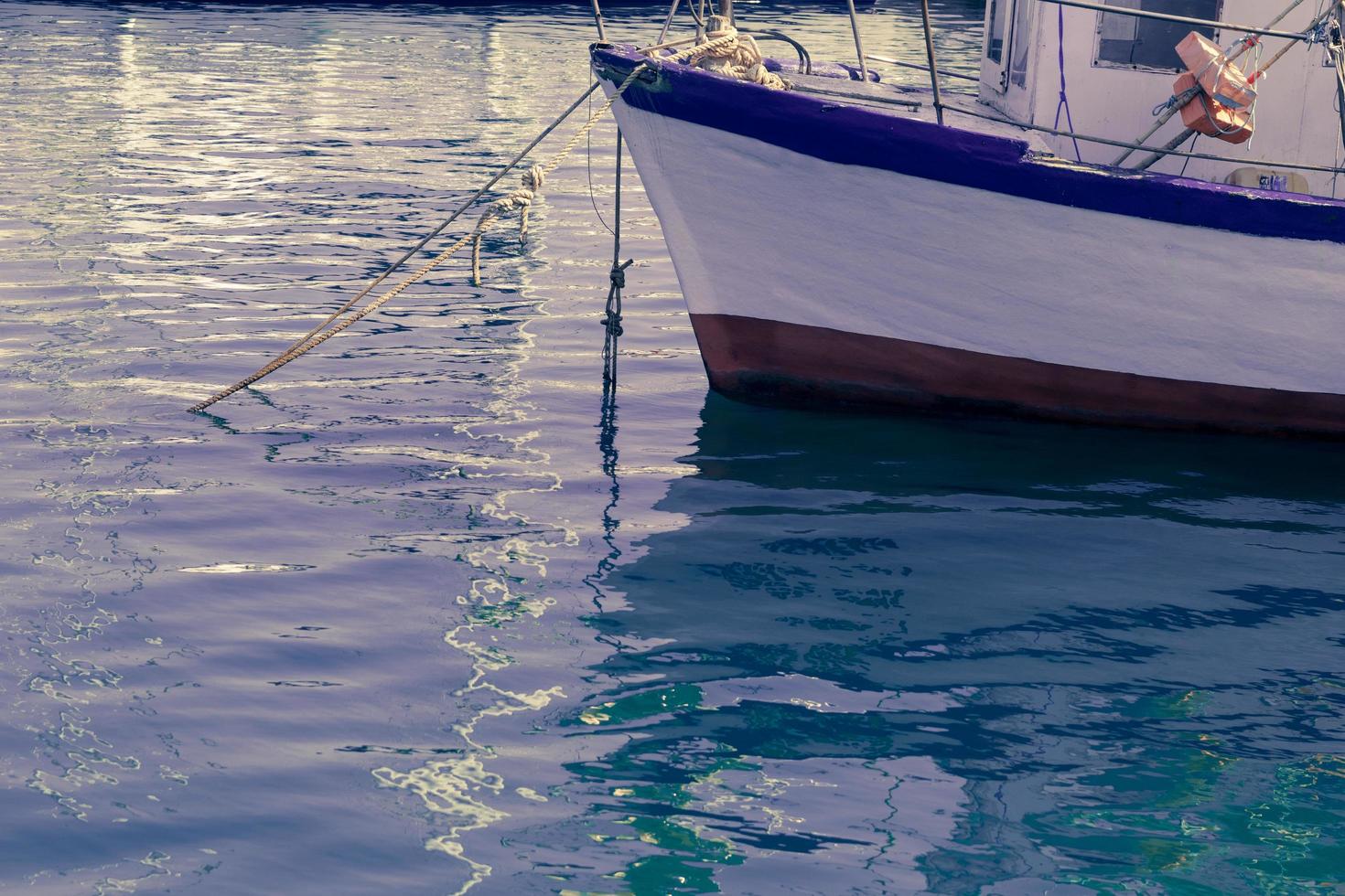 A photograph of a ship and a luxury yacht anchored in port. Beautiful photo of a Mediterranean port