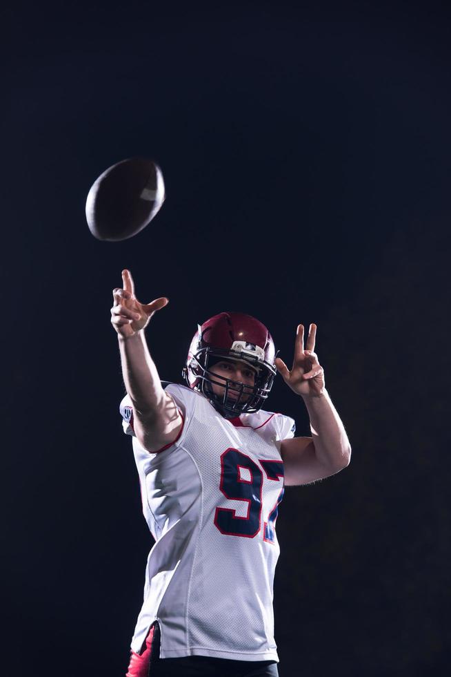 american football player throwing rugby ball photo