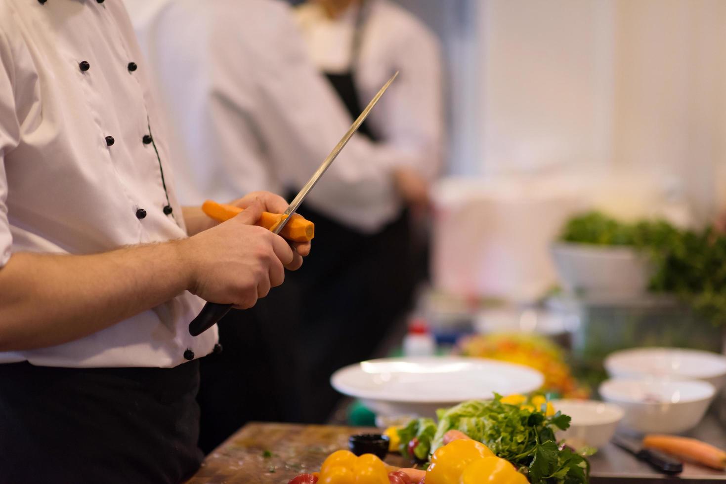 chef hands cutting carrots photo