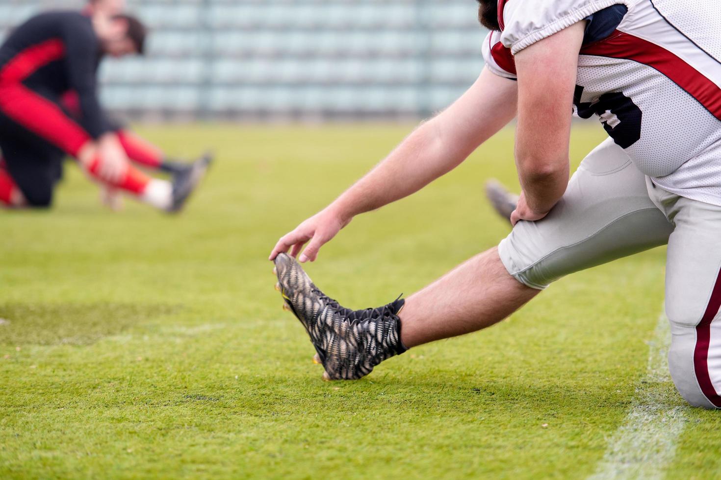 american football players stretching and warming up photo