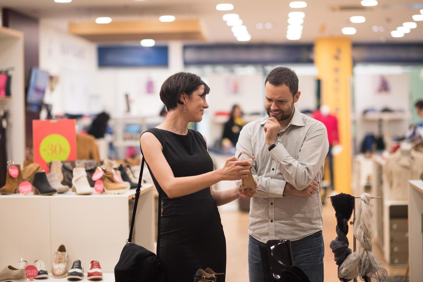 couple chooses shoes At Shoe Store photo
