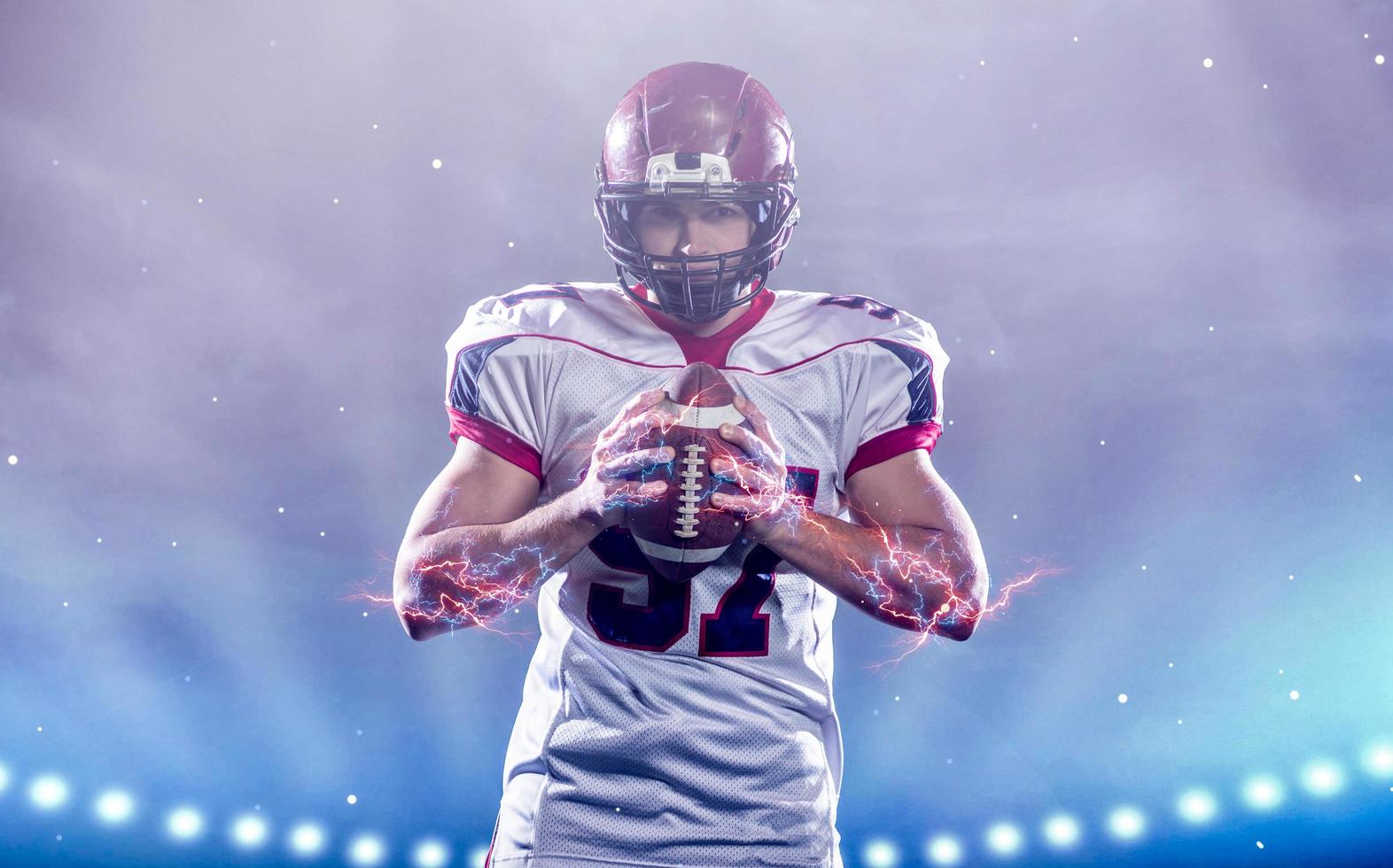 portrait of confident American football player standing on the field photo