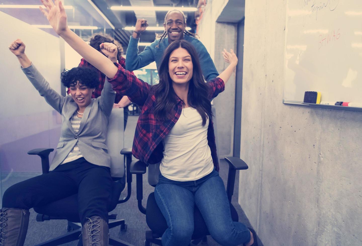 multiethnics business team racing on office chairs photo