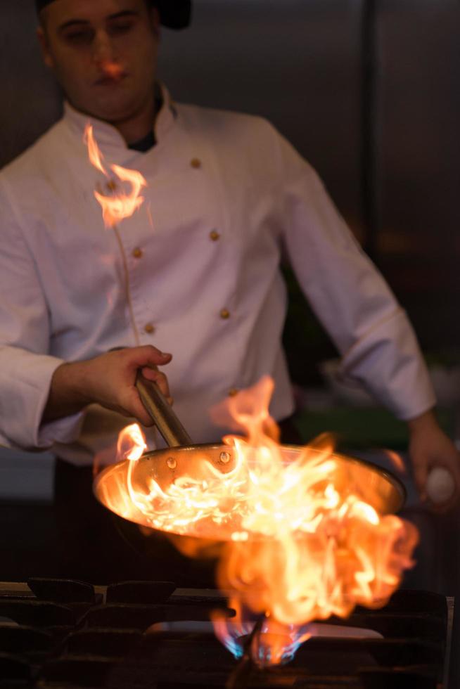 Chef doing flambe on food photo