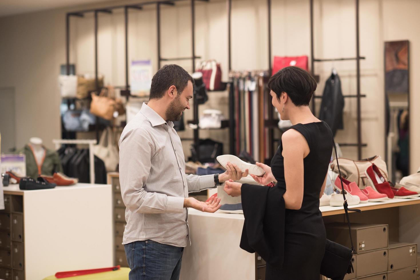 couple chooses shoes At Shoe Store photo