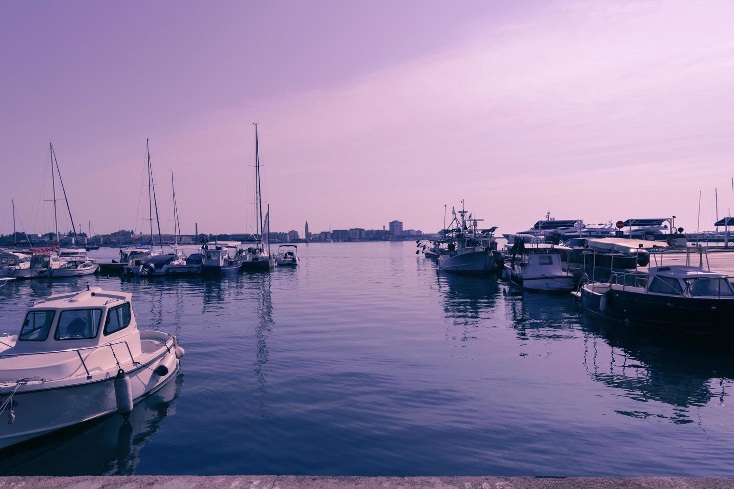 A photograph of a ship and a luxury yacht anchored in port. Beautiful photo of a Mediterranean port
