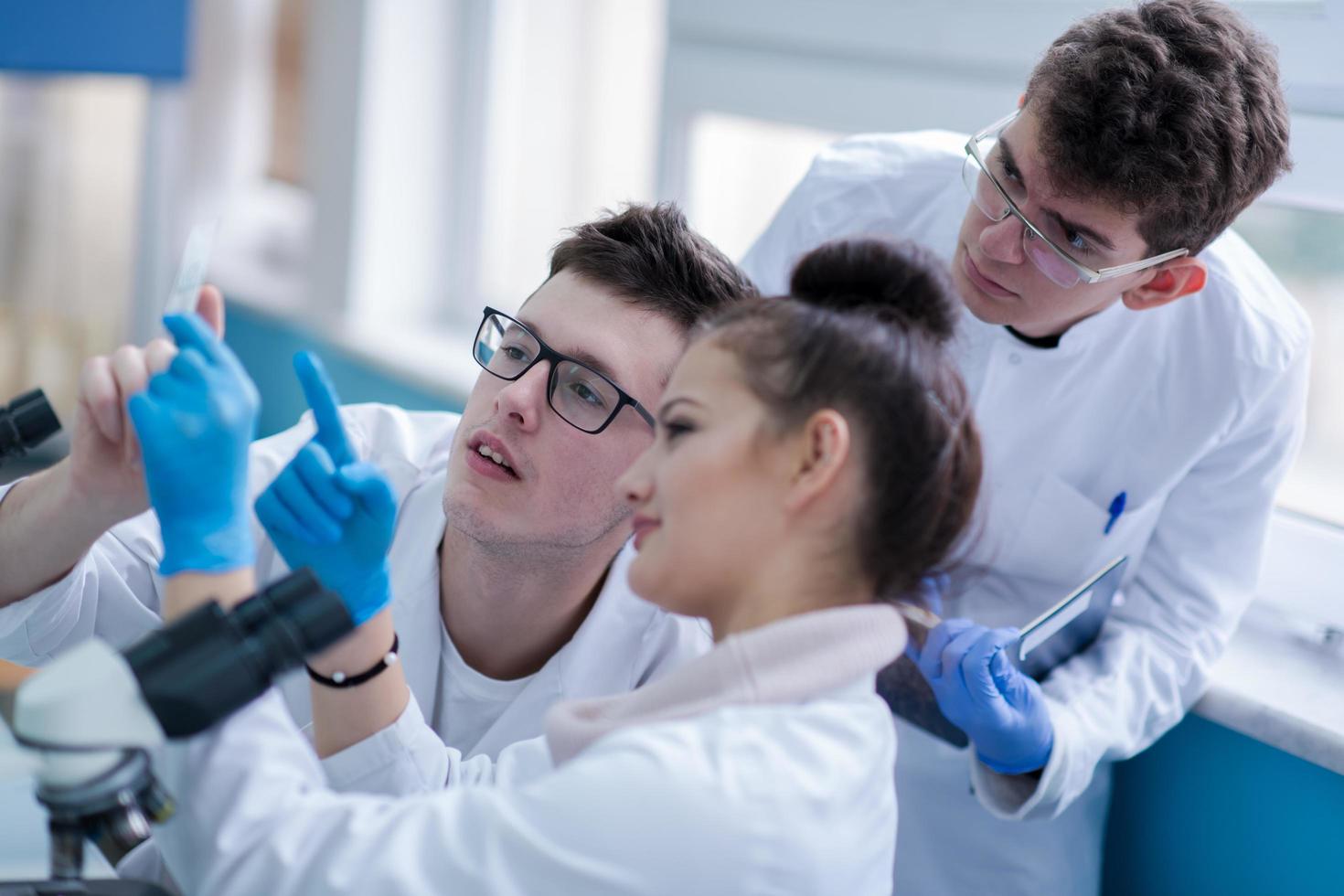 Group of young medical students doing research photo