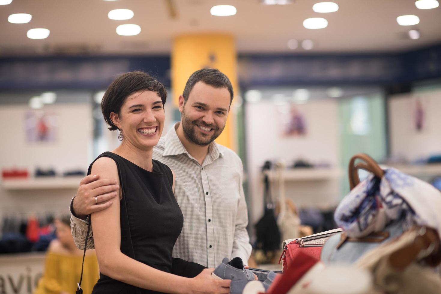 couple chooses shoes At Shoe Store photo