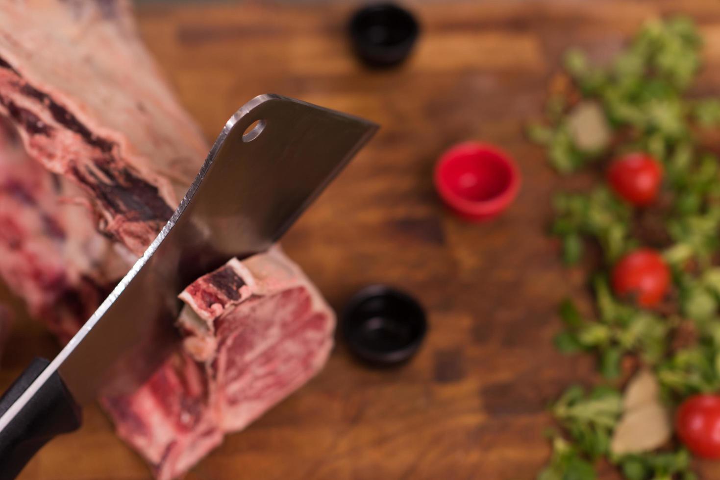 chef cutting big piece of beef photo