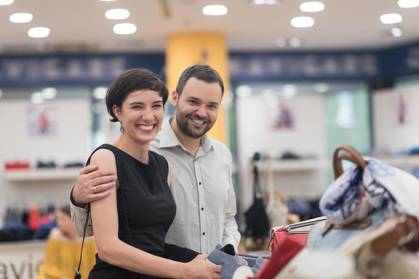 couple chooses shoes At Shoe Store photo