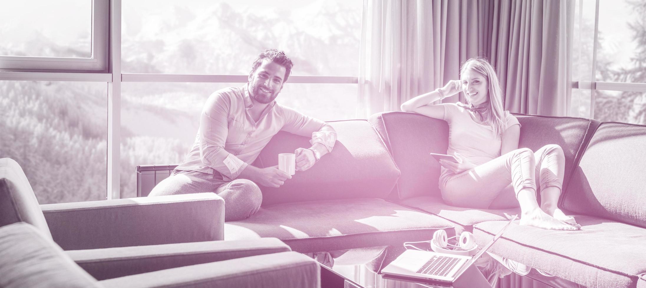 couple relaxing at  home using tablet computer photo