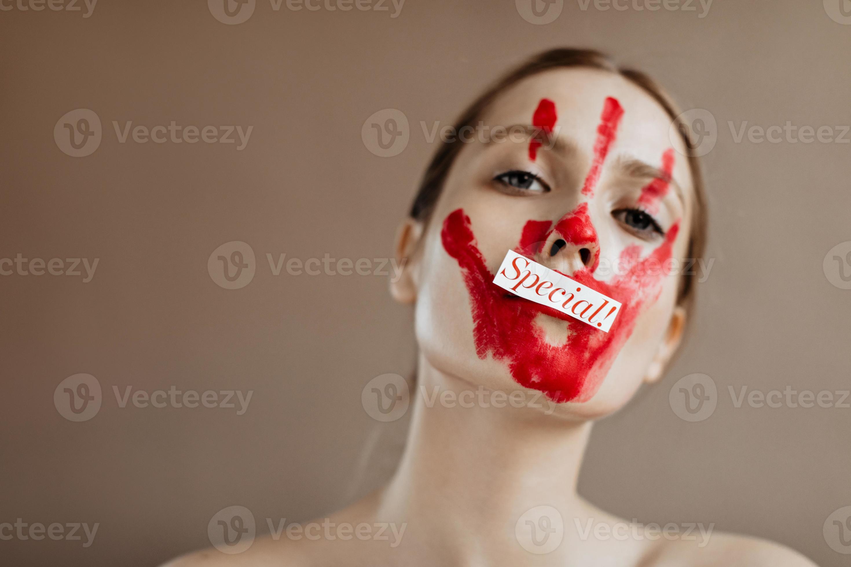 Woman with red handprint on her face and inscription special looks into
