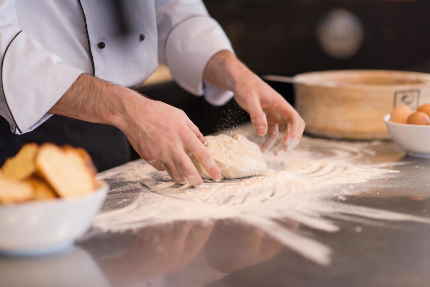 chef hands preparing dough for pizza photo