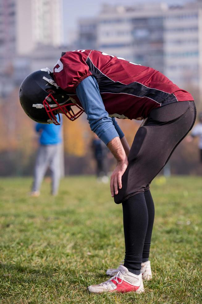 american football player resting after hard training photo