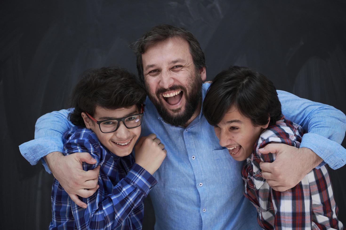 happy father hugging sons photo