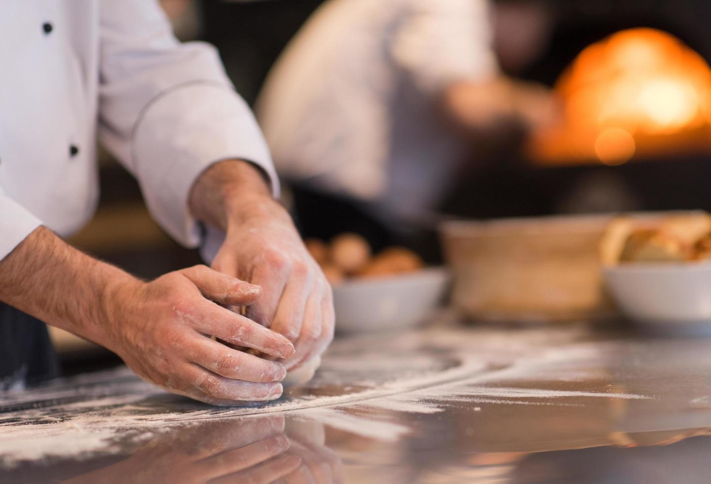 chef hands preparing dough for pizza photo