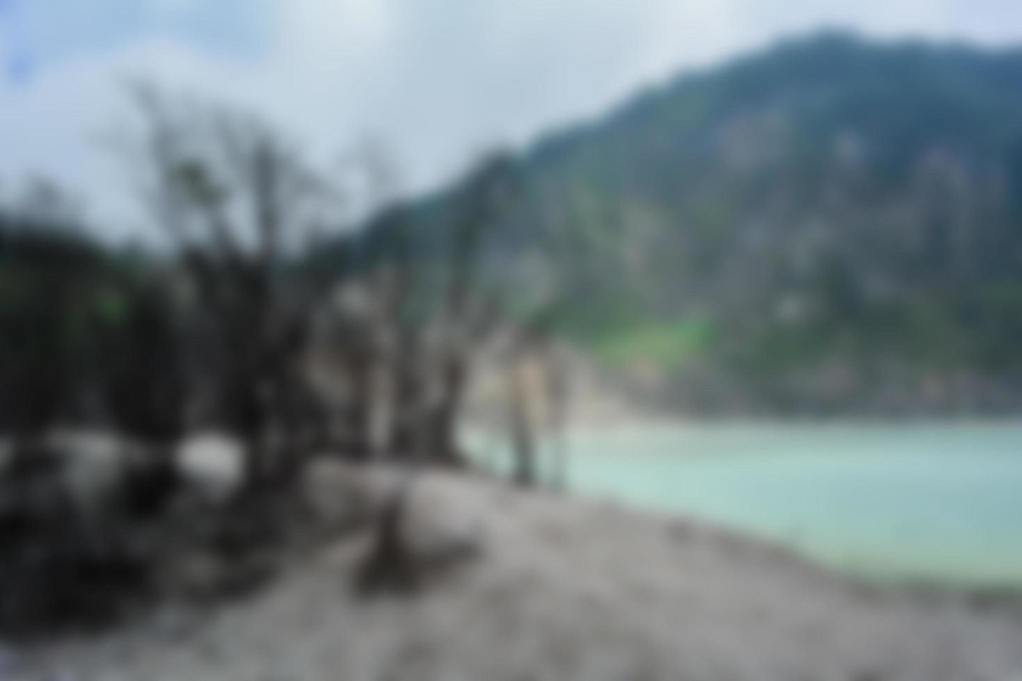 Blurred view of Kawah Putih, white crater, a hot volcanic lake. Tourist destination in South of Bandung, West Java, Indonesia. photo