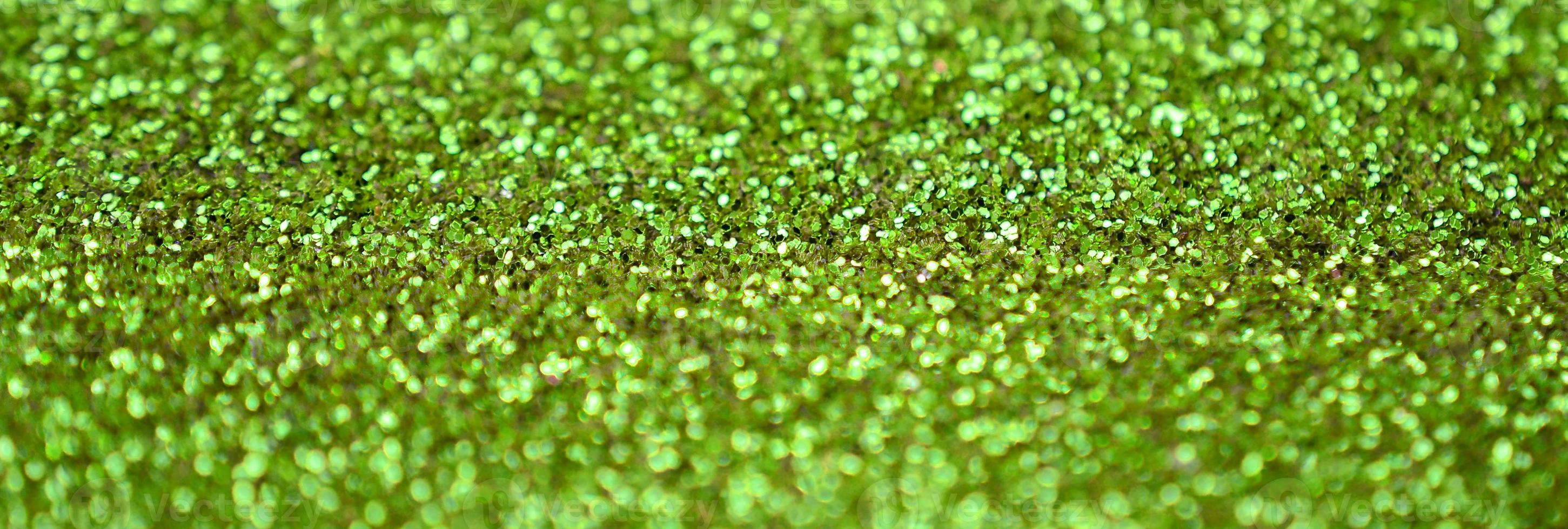 Lime green decorative sequins. Background image with shiny bokeh lights from small elements photo