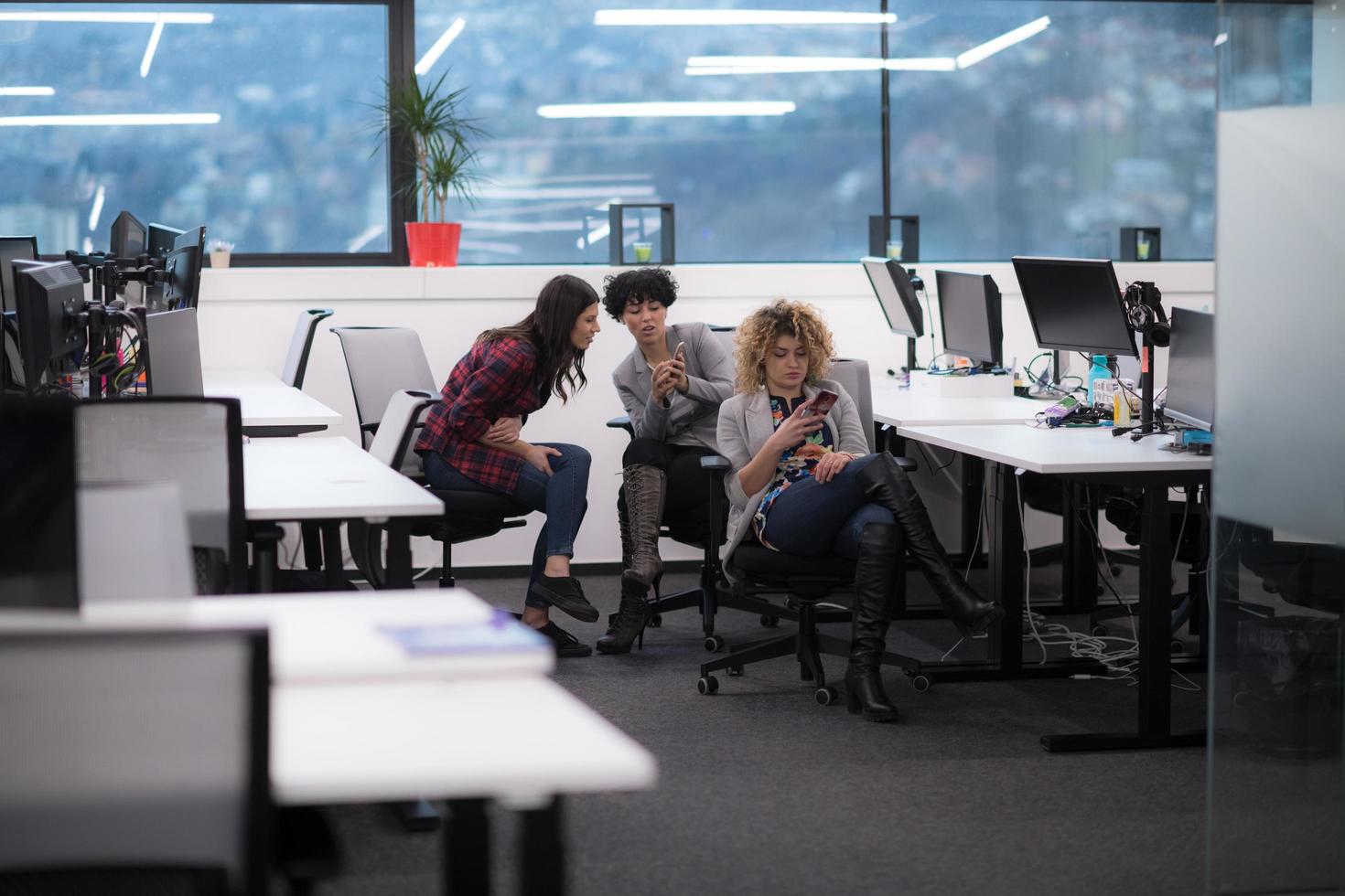 female software developers using mobile phones photo