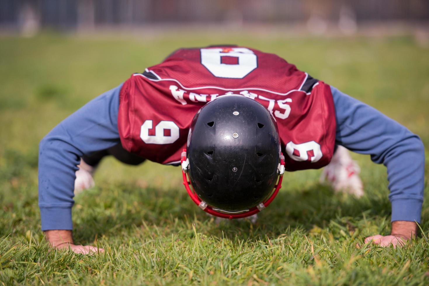 american football player doing push ups photo