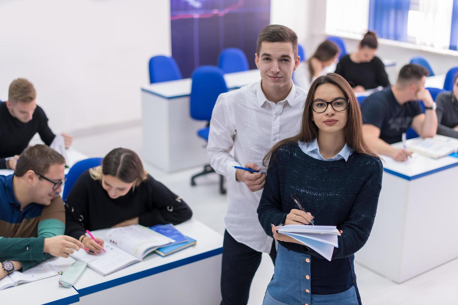 young students writing notes photo