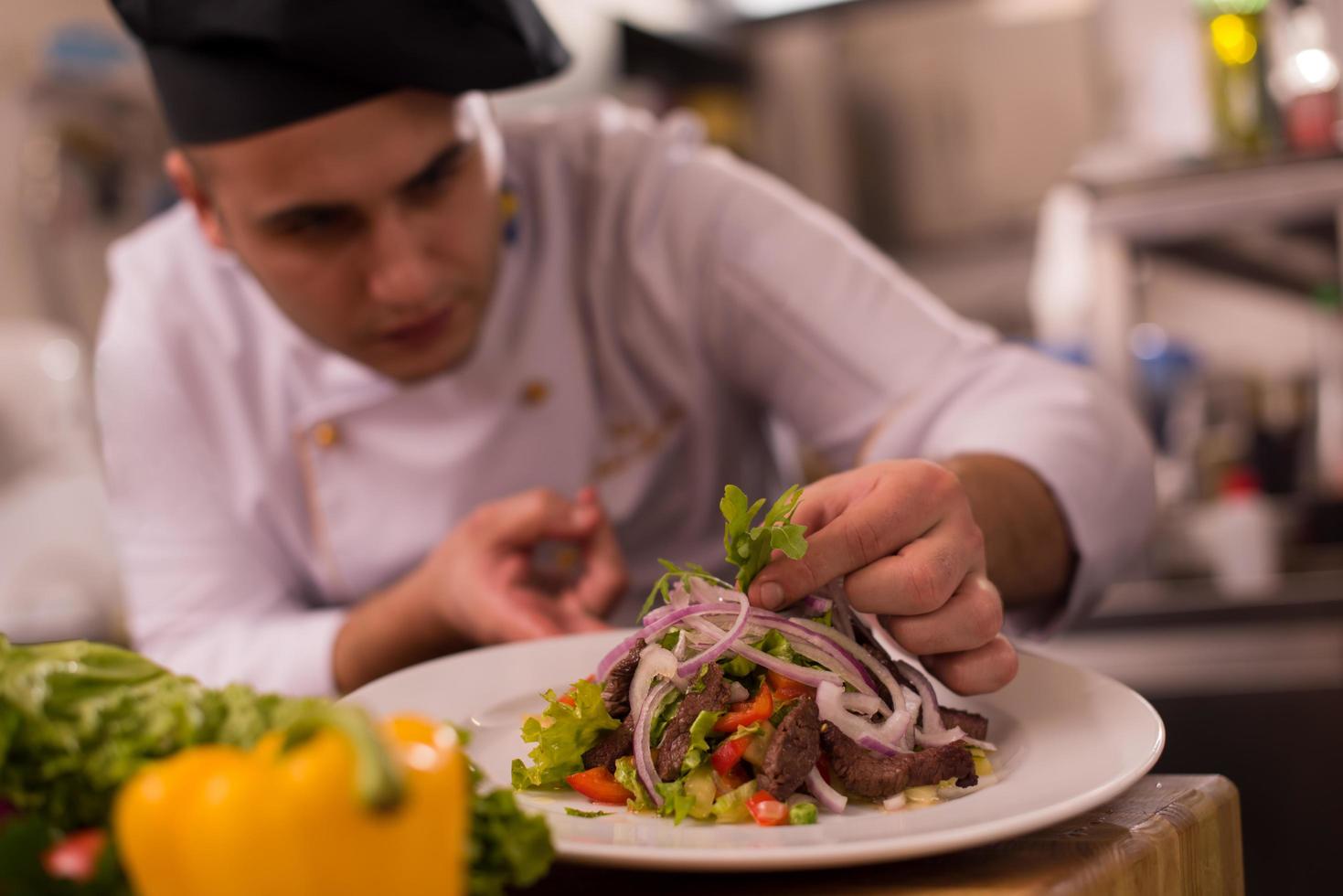 cook chef decorating garnishing prepared meal photo