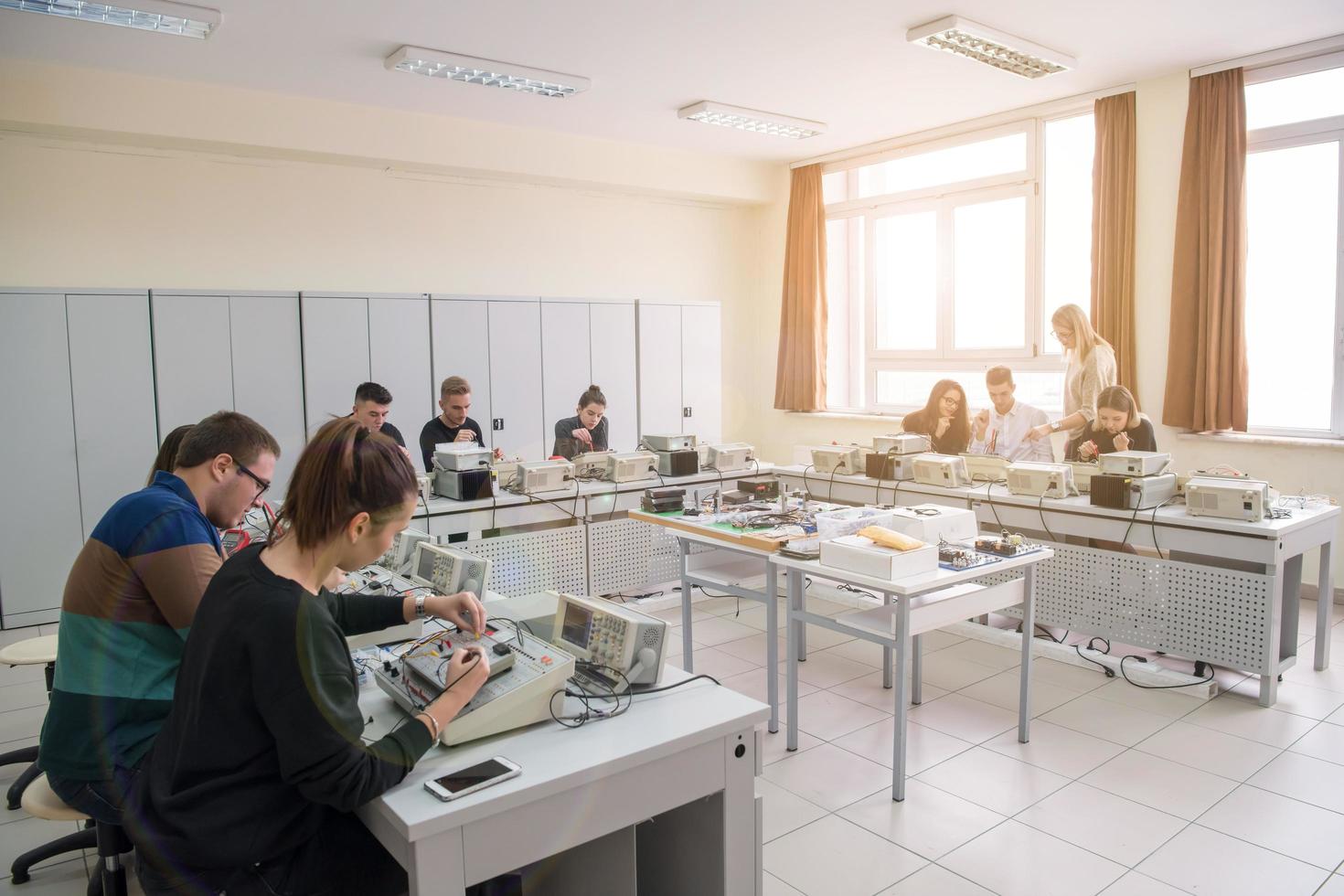 students doing practice in the electronic classroom photo