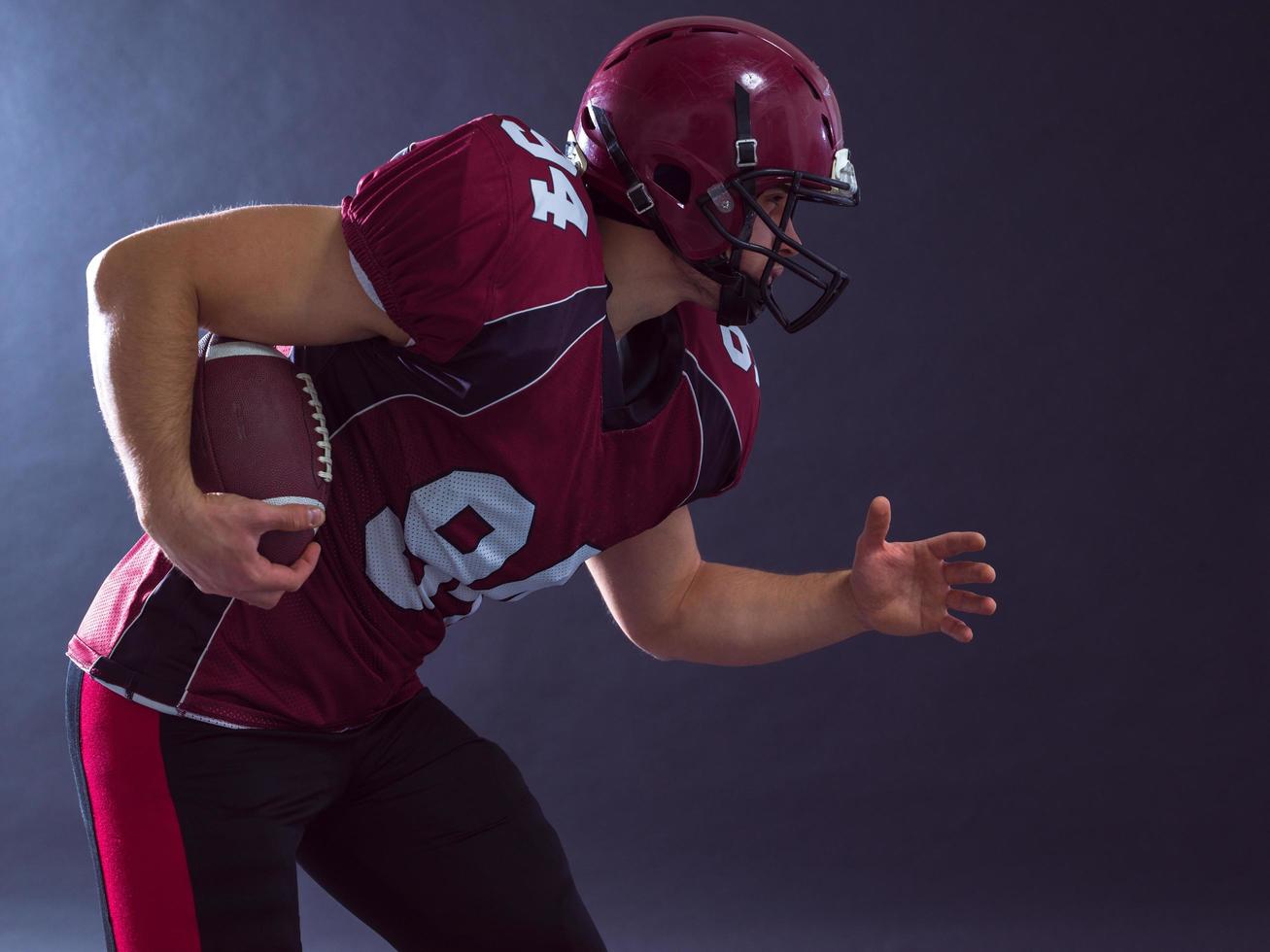 American football Player running with the ball photo