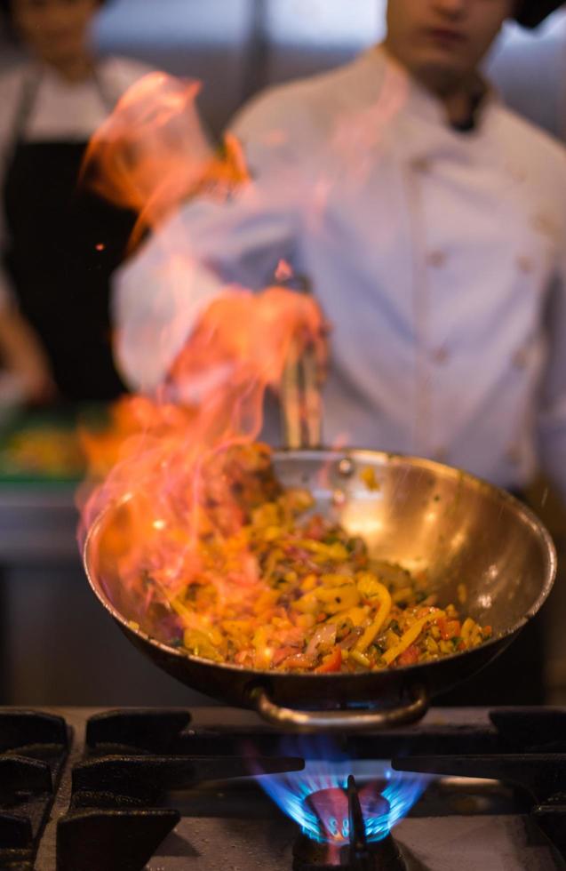 Chef doing flambe on food photo