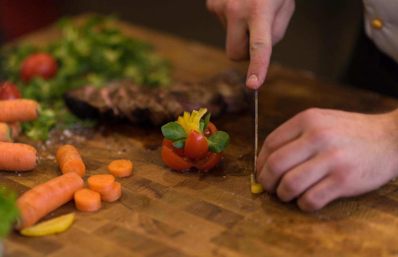 closeup of Chef hands preparing beef steak photo