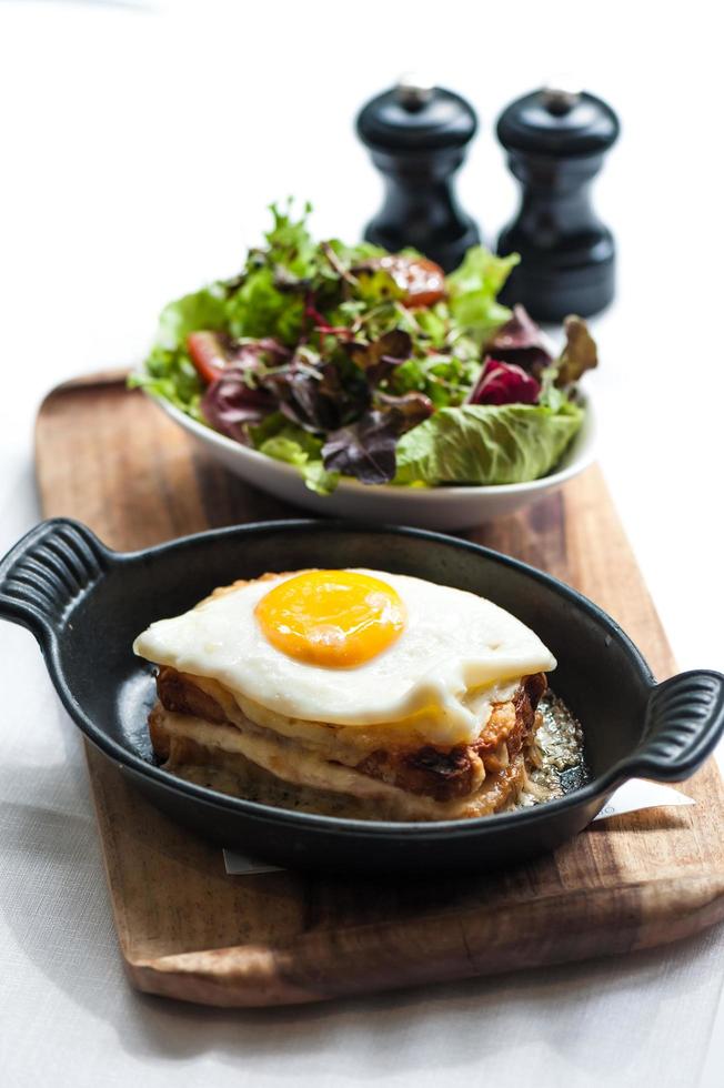 Breakfast menu with beautiful fried eggs, bread and ham photo