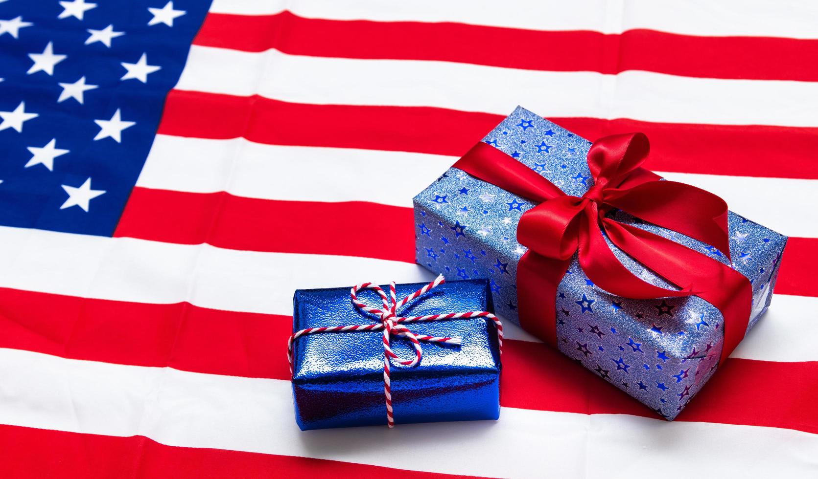 Happy Veterans Day concept. American flags with gift box against a blackboard background. November 11. photo