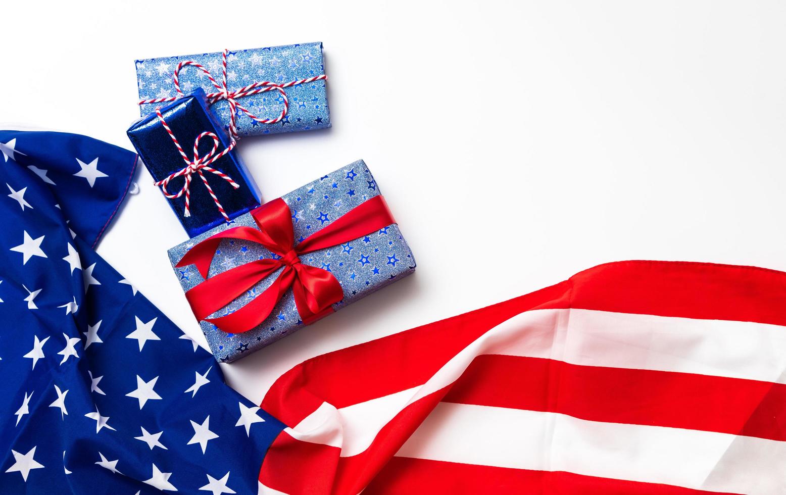 Happy Veterans Day concept. American flags with gift box against a blackboard background. November 11. photo
